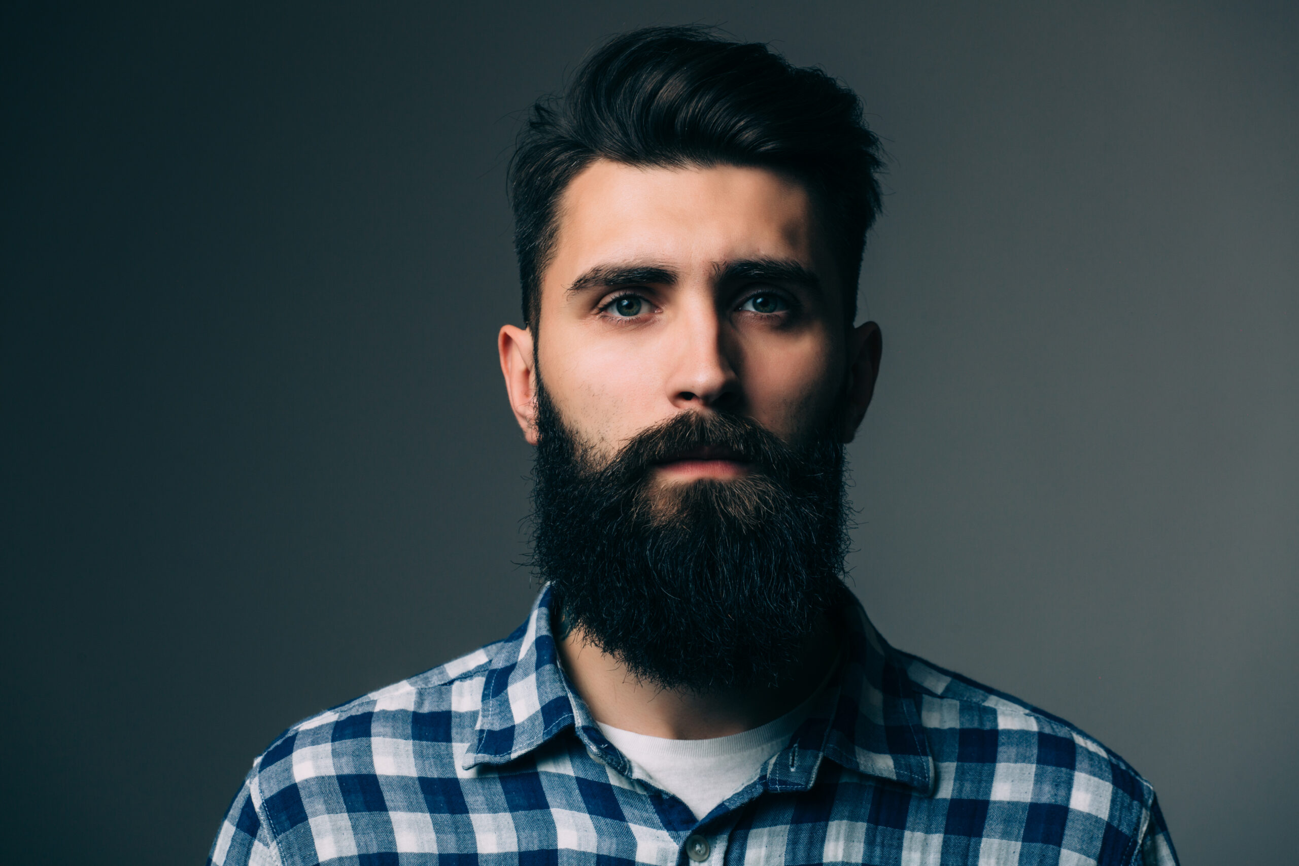 portrait masculinity portrait handsome young bearded man while standing against grey wall scaled