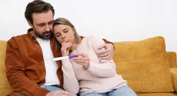 medium shot couple with pregnancy test 11zon.webp